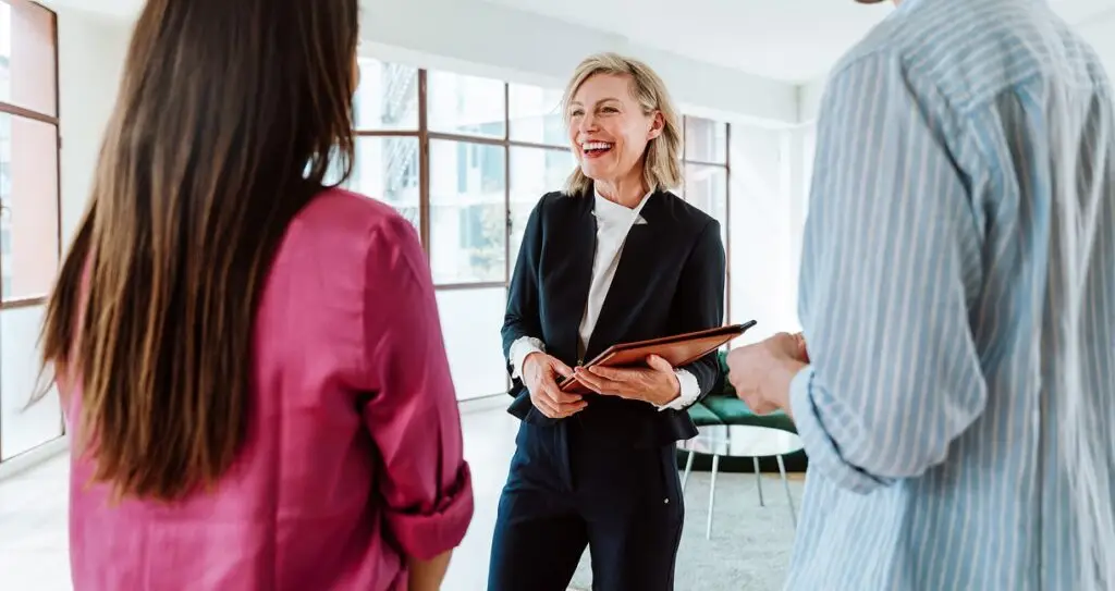 An Estate agent showing a couple around a home